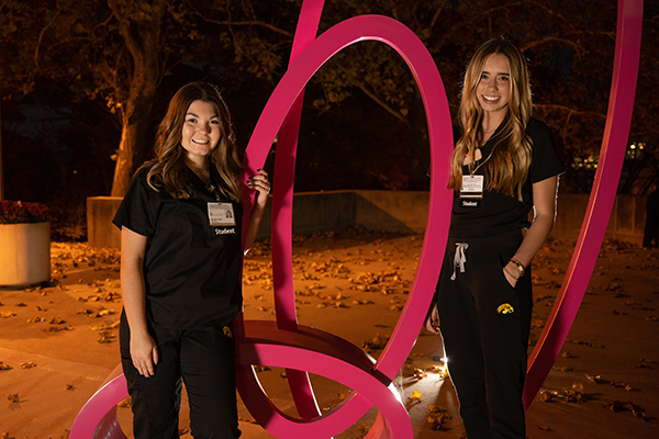 Grace Anderson and Hannah Ingle in front of College of Nursing Building