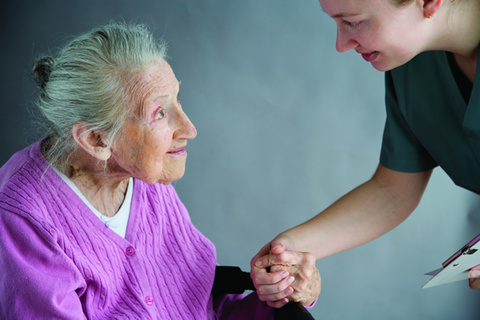 An old woman with a caregiver