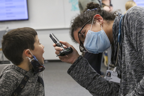 Nurse practitioner students talk with and check the vitals of a child at a pediatric simulation held for students in the NP program in the College of Nursing Building on Wednesday, Nov. 17, 2021. Students had a chance to apply their clinical skills in a low-stakes setting by practicing well checks on children of various ages.