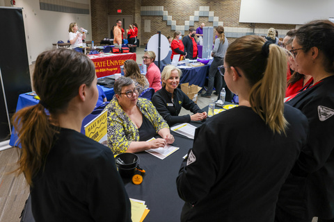 Cheri Doggett, academic program management specialist, RN-BSN (left) and Brenda Duree (right) talk with students during a nursing college career fair at Southwest Community College in Creston, Iowa on Thursday, April 21, 2022.