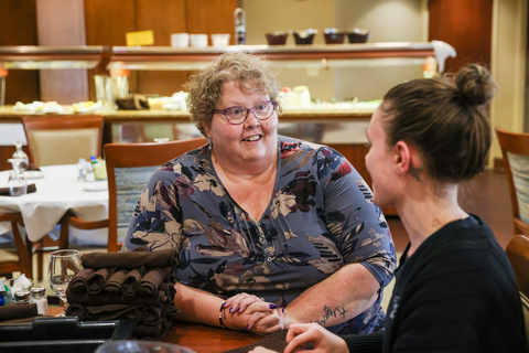 Kim Bergen-Johnson talks with an employee at Oaknoll, the Iowa City retirement community where she is the administrator.