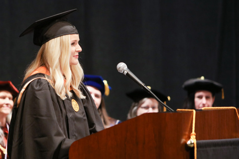 Olivia Wulf speaking at a past commencement ceremony. 