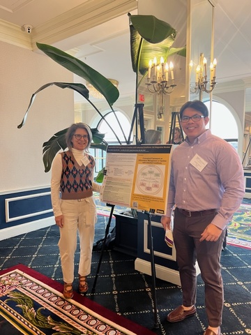 Sandy Daack-Hirsch and Peter Abad stand on either sides of a research poster