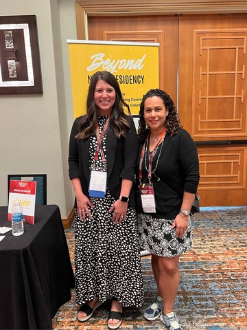 Nicole Weathers with Dr. Sheri Cosme posing in front of IONRP booth