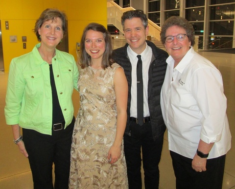 group of four people smiling at camera