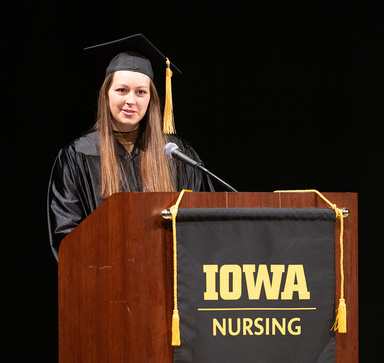 Monica Samples speaking at commencement podium