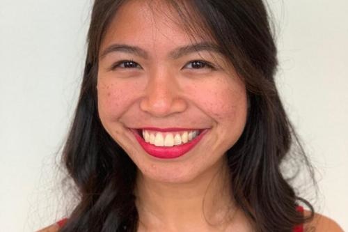 Smiling woman with long dark hair.