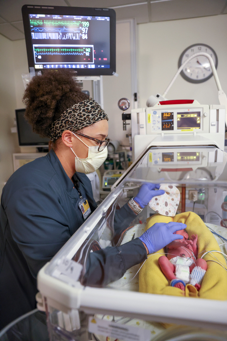 Alyssa Wessel, a first-semester RN-BSN student, checks on a premature baby in the Neonatal Intensive Care Unit where she works at the University of Iowa Hospitals and Clinics on Thursday, Sept. 29, 2022.