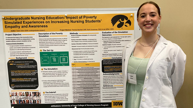 Taylor Saluri stands with her poster at the undergraduate research fair
