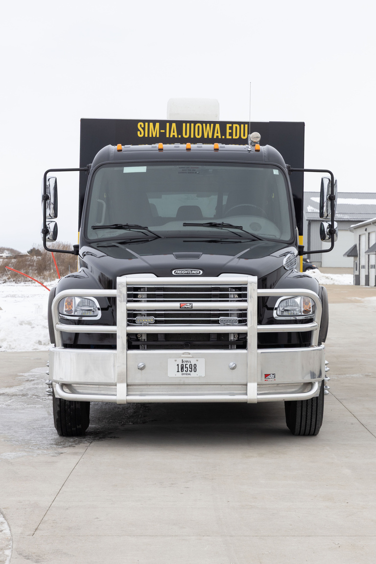 semi-type truck in black and gold from front
