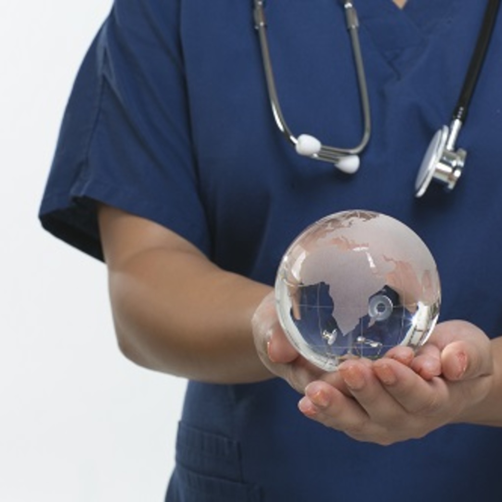 A healthcare professional holding a globe