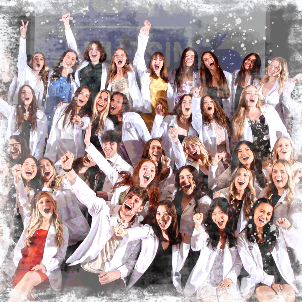 Group of students in white coats cheer