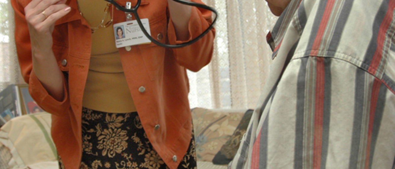 a nurse practitioner consults with an older male patient