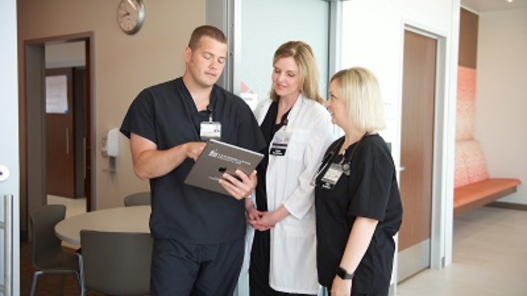 An MSN student speaking with two nurses