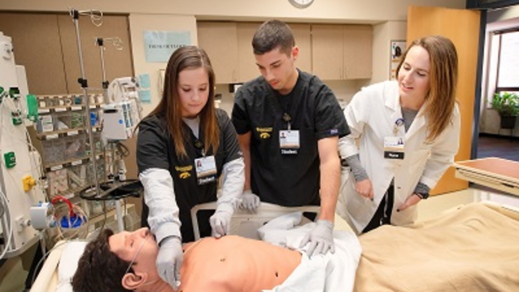 Students and an instructor with a mannequin at Nursing Clinical Education Center