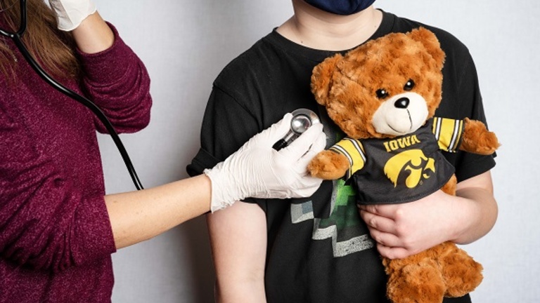 A nurse practitioner examining a young patient