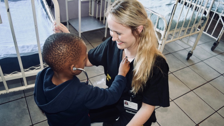 A student with a child in Eswatini