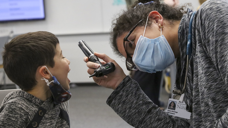 Nurse practitioner students talk with and check the vitals of a child at a pediatric simulation held for students in the NP program in the College of Nursing Building on Wednesday, Nov. 17, 2021. Students had a chance to apply their clinical skills in a low-stakes setting by practicing well checks on children of various ages.